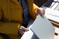 A woman inspects newly purchased laptop defects