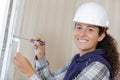 Woman installing door handle using screwdriver Royalty Free Stock Photo