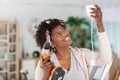 woman installing light in home using cordless power-tool Royalty Free Stock Photo
