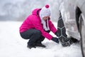 Woman installing snow chain