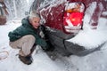 Woman installing tire chains