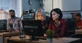 Woman instructing coworker at a support center