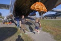 woman instructor teaching little girl how to handle parachute using flying landing simulator, airshow. Kyiv, Ukraine Royalty Free Stock Photo