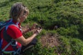 Woman intent on photographing a marmot with a smartphone