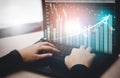 Woman interacting with laptops, phones, and tablets with featuring stock tickers or graphs, cryptocurrency and new trading platfor Royalty Free Stock Photo