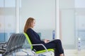 Woman in international airport terminal, working on her laptop Royalty Free Stock Photo