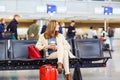 Woman at international airport waiting for flight Royalty Free Stock Photo