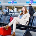 Woman at international airport waiting for flight at terminal Royalty Free Stock Photo