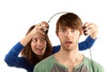 Woman interupts man with headphones Royalty Free Stock Photo