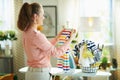 Woman with iron and clothes basket happy with laundry result Royalty Free Stock Photo