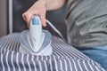 Woman ironing clothes on the ironing board with modern iron Royalty Free Stock Photo