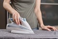 Woman ironing clothes on the ironing board with modern iron Royalty Free Stock Photo