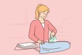 Woman ironing clothes on an ironing board