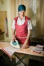 Woman Ironing in the Kitchen Royalty Free Stock Photo