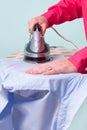 Woman ironing a shirt Royalty Free Stock Photo