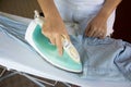 Woman ironing shirt on ironing board Royalty Free Stock Photo