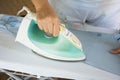 Woman ironing shirt on ironing board Royalty Free Stock Photo