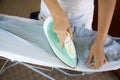 Woman ironing shirt on ironing board Royalty Free Stock Photo