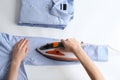 Woman ironing shirt on light background Royalty Free Stock Photo