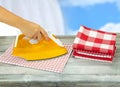 Woman ironing tablecloths on rustic grey table with a blue white Royalty Free Stock Photo