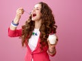 Woman isolated on pink background eating farm organic yogurt