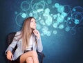 Woman in jacket, blouse sits on chair and looking Royalty Free Stock Photo