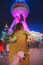Woman in jacket clothes leading man to oriental pearl tower in shanghai Royalty Free Stock Photo