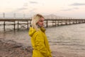 Woman in jacket near sea at sunrise cold morning Royalty Free Stock Photo