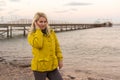 Woman in jacket near sea at sunrise cold morning Royalty Free Stock Photo