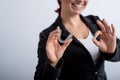 The woman in the jacket shows the ok sign and demonstrates the mouth guards to align the bite. The girl approves of the