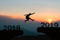 Woman jacket traveling on a cold morning sunHappy New Year 2019 Men jump over silhouette mountains Royalty Free Stock Photo