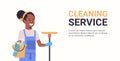 Woman janitor holding bucket with tools and mop cleaning service concept smiling african american female cleaner Royalty Free Stock Photo