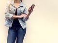 Woman in jeans fashion holding mobile phone