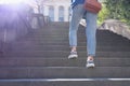 Woman in jeans going up steep stairs Royalty Free Stock Photo