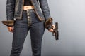 Woman in jeans is holding a gun Royalty Free Stock Photo