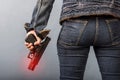 Woman in jeans is holding a gun Royalty Free Stock Photo