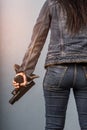 Woman in jeans is holding a gun Royalty Free Stock Photo