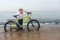 Woman in jeans standing in the water on a beach Royalty Free Stock Photo