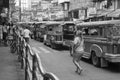 Woman and Jeepneys in Quezon.
