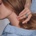 Woman Jewelery concept. Woman hands close up wearing rings, earrings