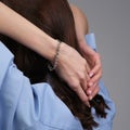 Woman Jewelery concept. Woman hands close up wearing rings, earrings