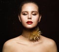 Woman Jewelry Necklace. Fashion Girl in Gold Collar with Thorns. Eyes closed Model in golden Makeup. Black Background