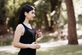 Woman jogger enjoy music in wireless earphones