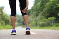 Woman jogger hold her sports injured leg Royalty Free Stock Photo