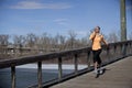 Woman jogging on bridge