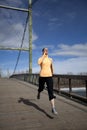 Woman jogging on bridge