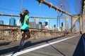 Woman jogging on Brooklyn Bridge, New York