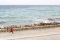 Woman jogging on city street at seaside