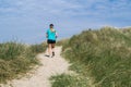 Woman jogging in the dunes Royalty Free Stock Photo