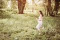 Woman jogging in field. Young woman in meadow.